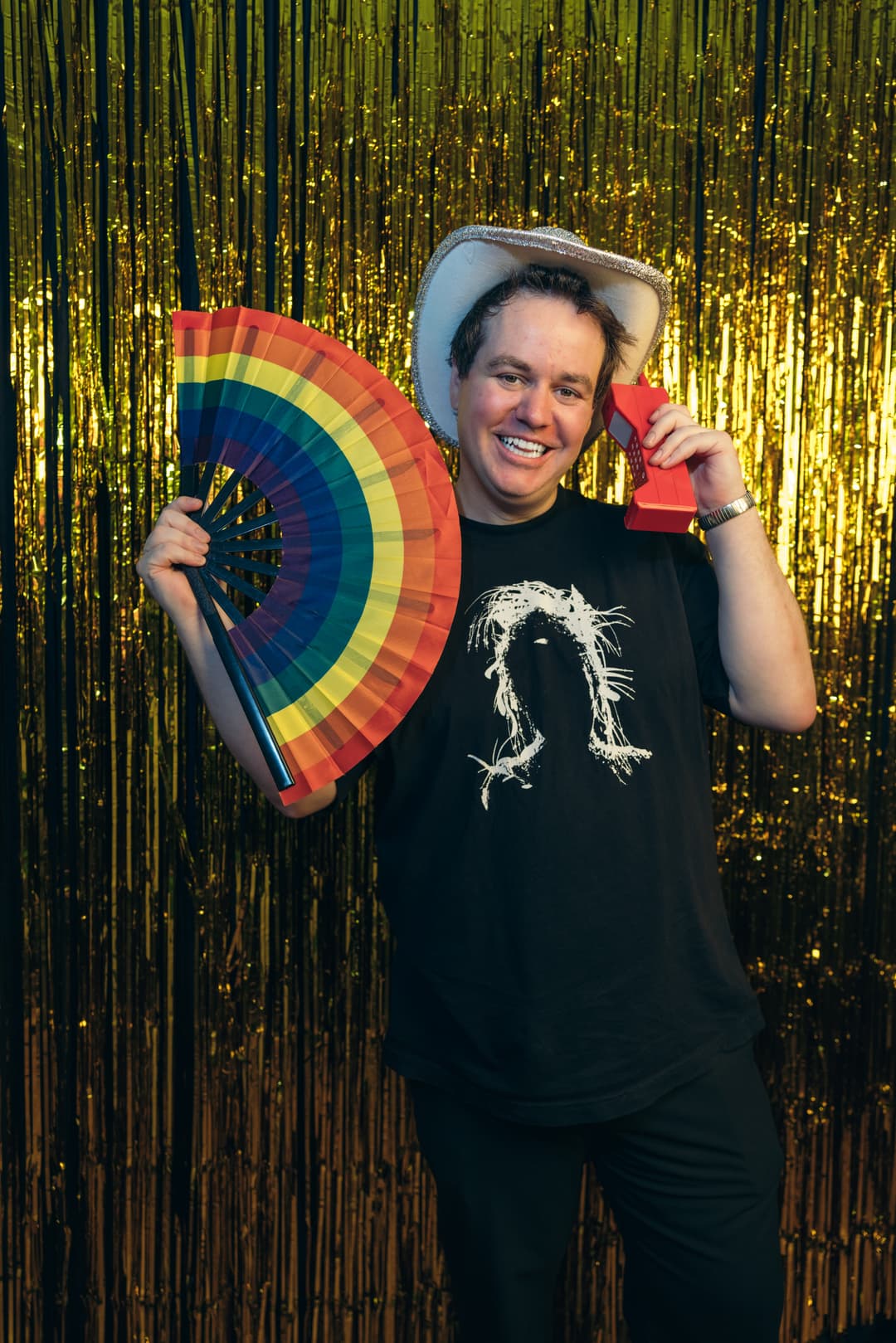 NYC photo booth rental - Ben Hawes, owner of Rent My Booth, hosting a corporate event with rainbow fan props